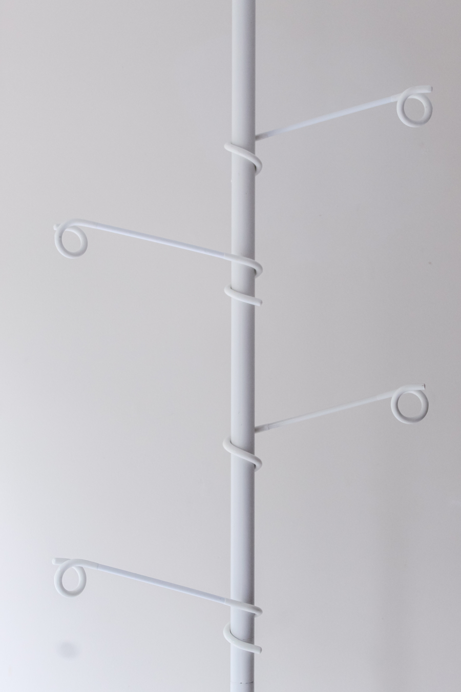 The stand shown with different hook and tray combinations